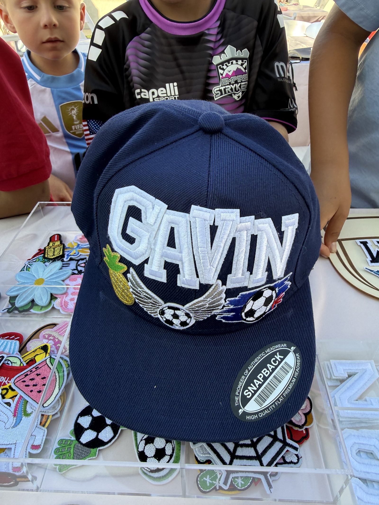 Custom GAVIN hat at a heat press bar in Los Angeles